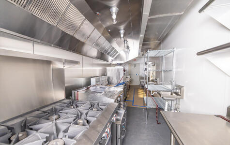Trusscore white wallandceilingboard installed in a ROXBOX shipping container kitchen